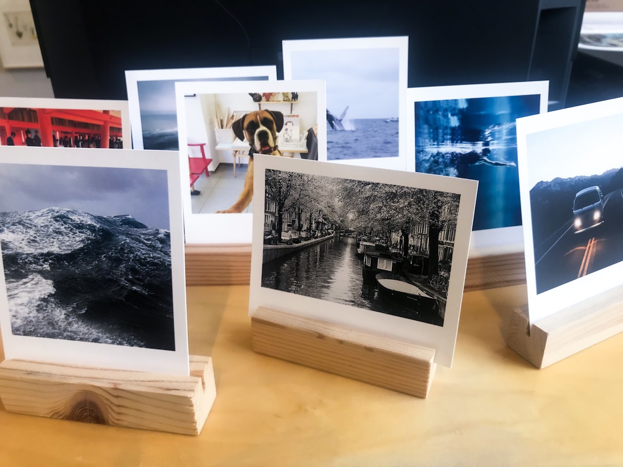 Različni formati tiskanih fotografij razporejeni na delovni mizi
